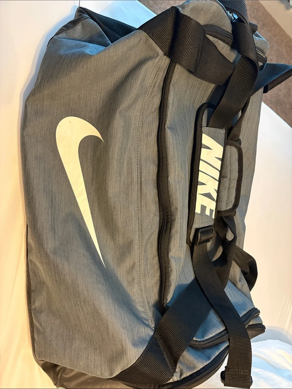 Nike Gray Duffel Bag with White Swoosh and Black Straps